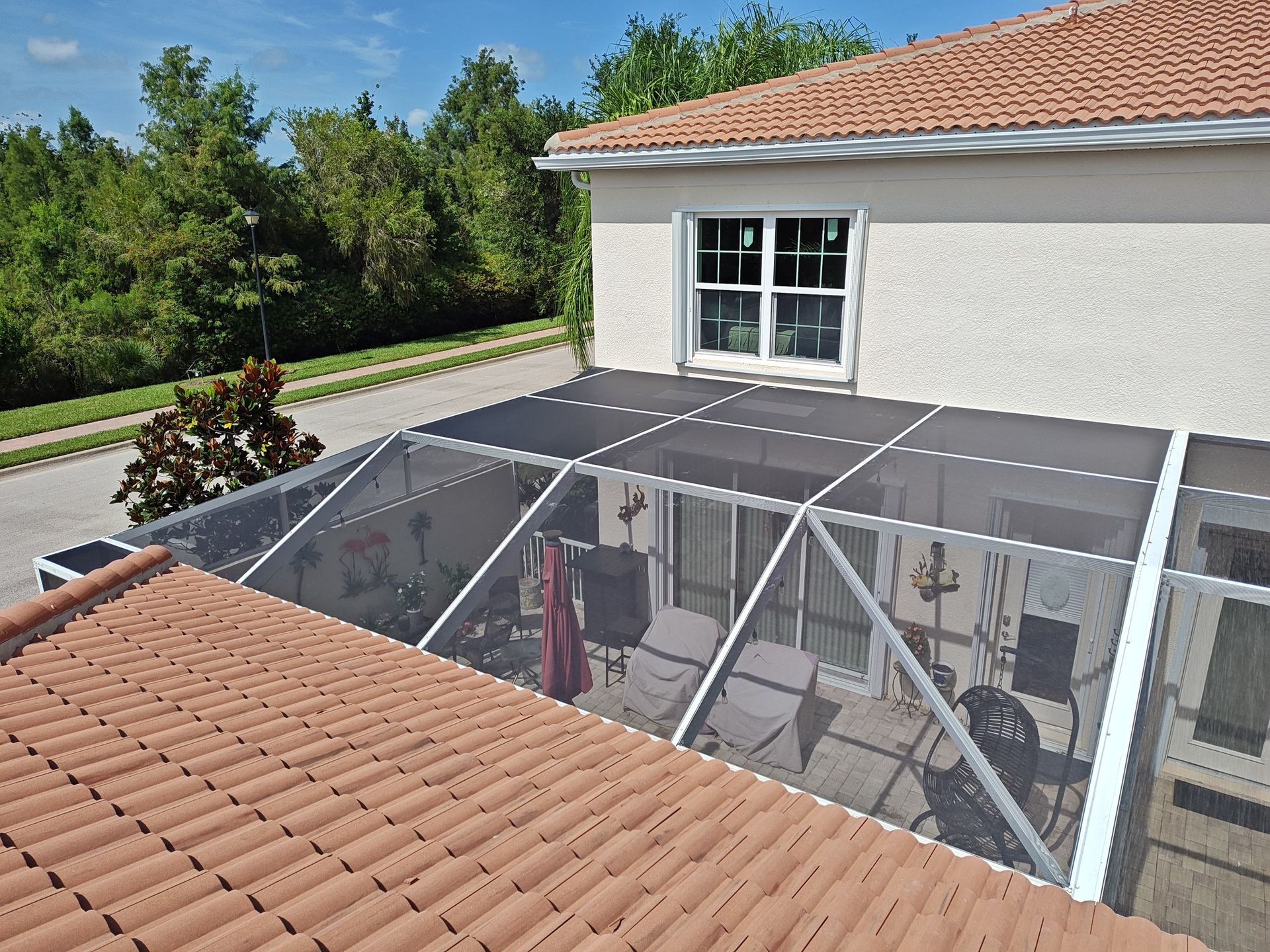 An aerial view of a house with a screened in porch.