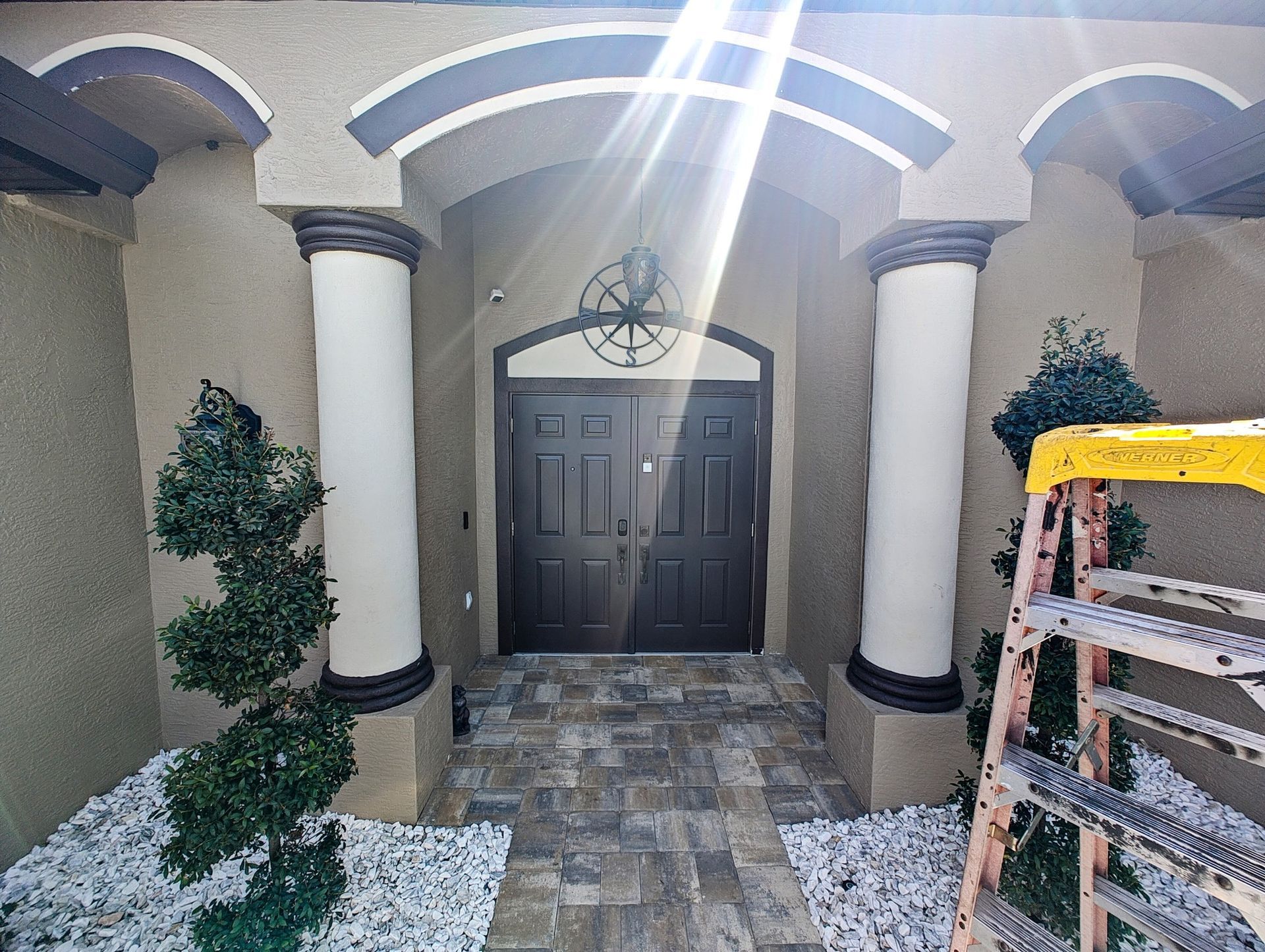 The front door of a house with a ladder in front of it