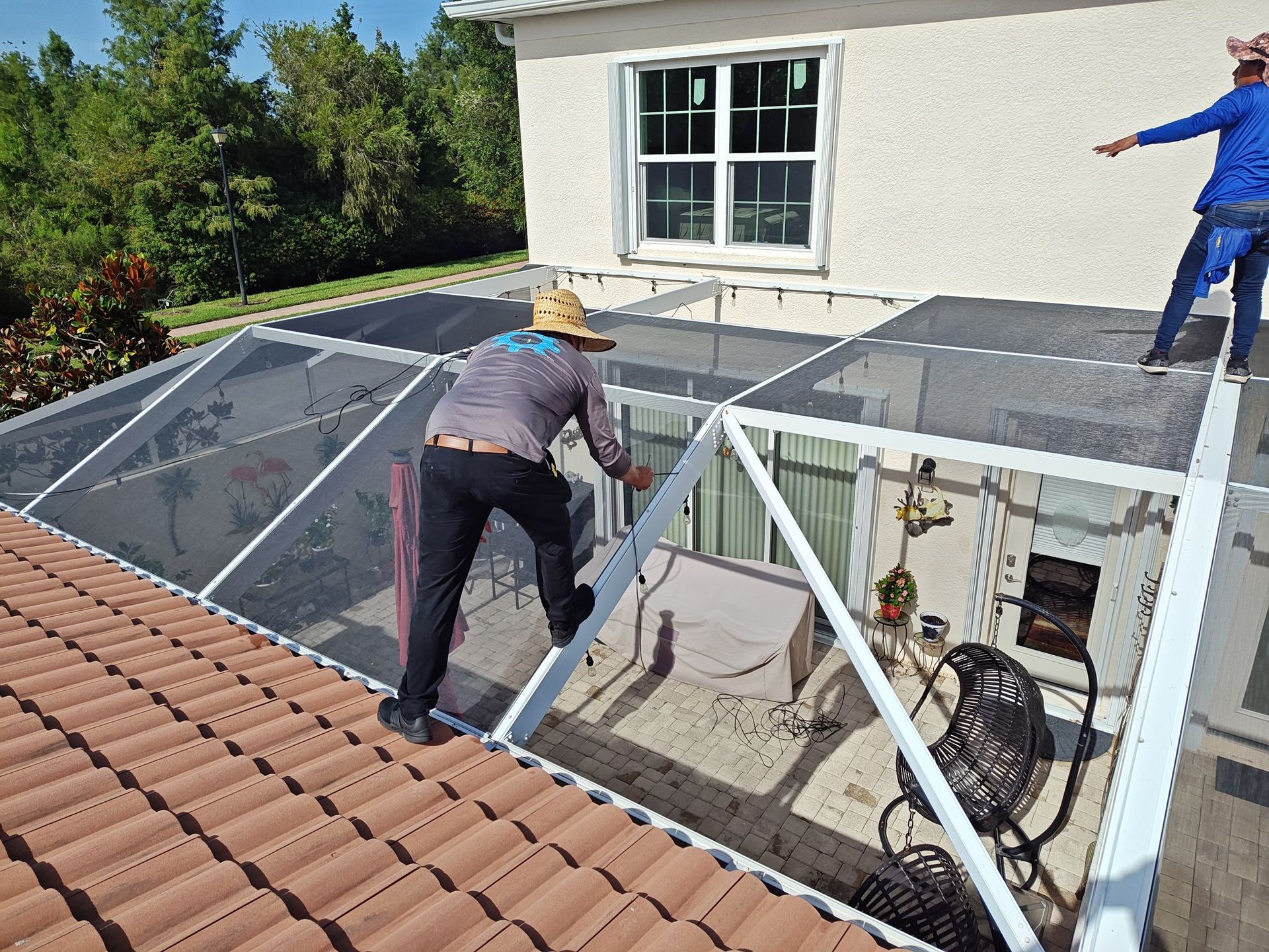 A man is working on the roof of a house.