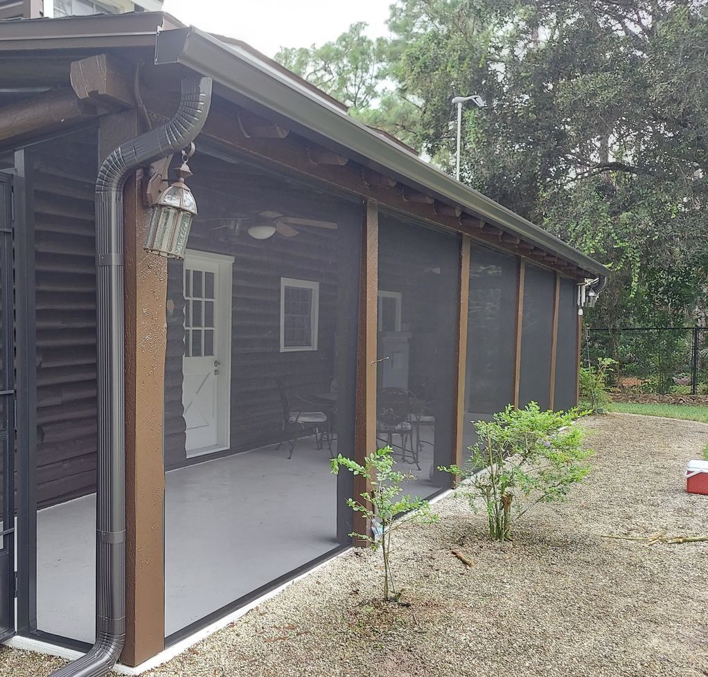 A screened in porch with a cooler in front of it