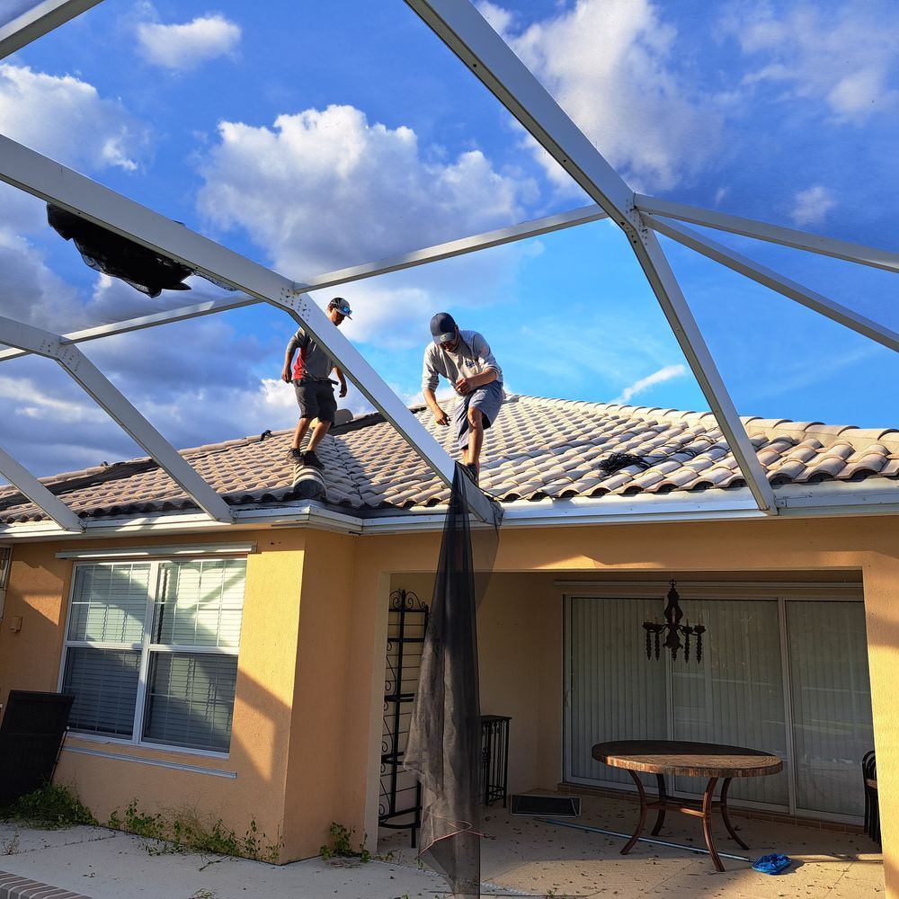 Two men are working on the roof of a house with the number 1441 on the window