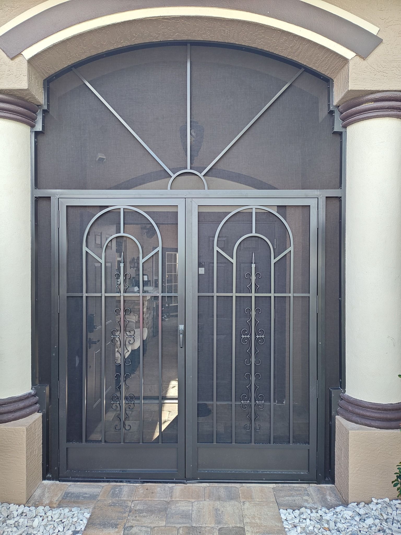 A screen door with a reflection of a person in it