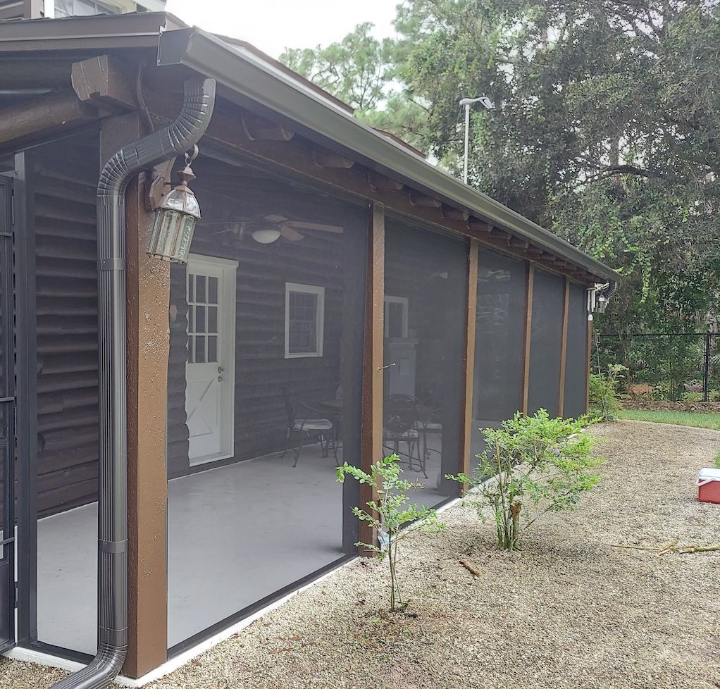 A screened in porch in front of a house
