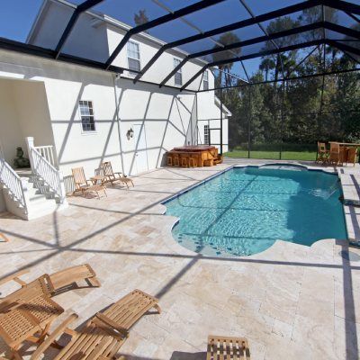 A large swimming pool in the backyard of a house