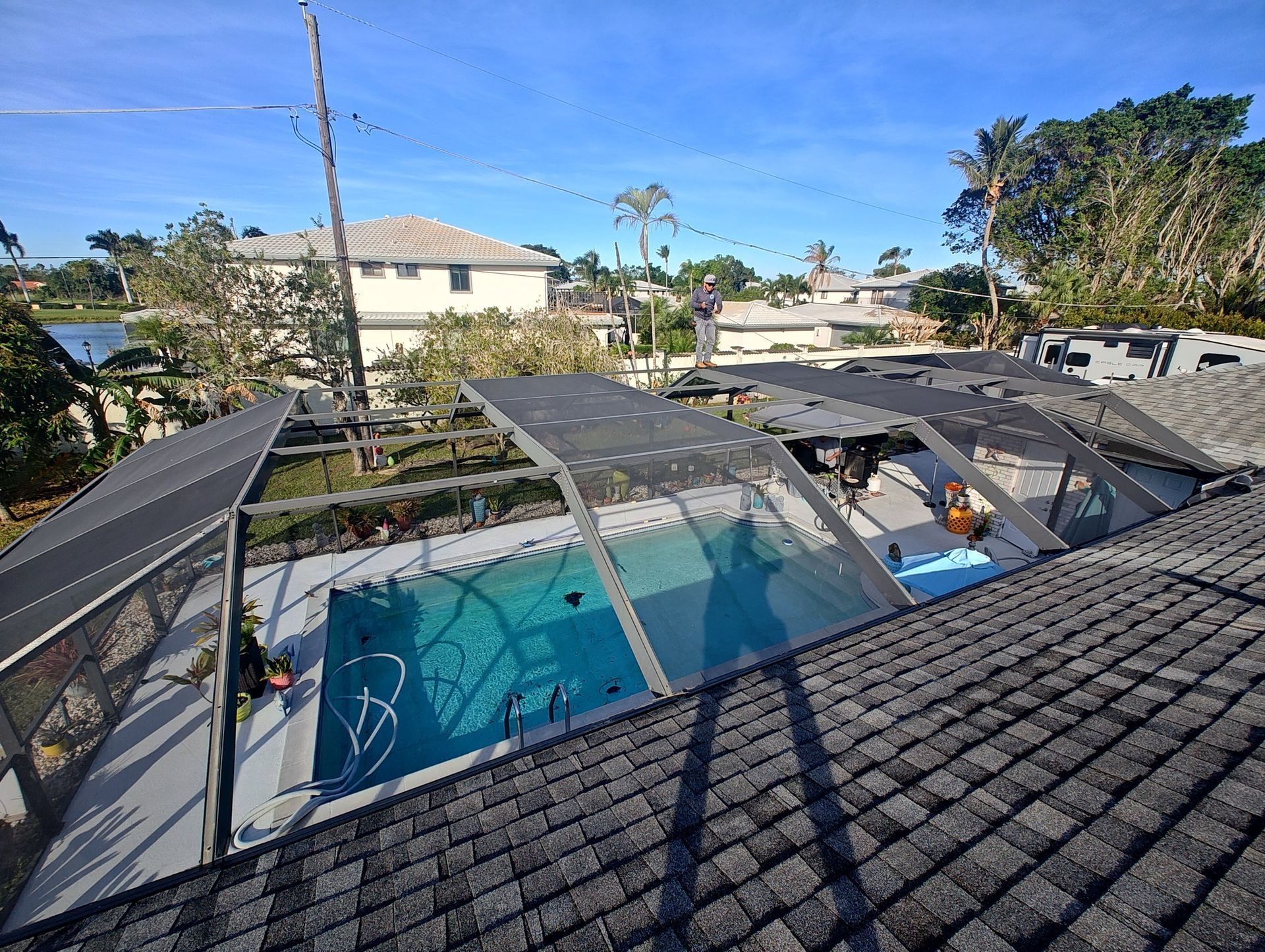 A view of a swimming pool from the roof of a house.