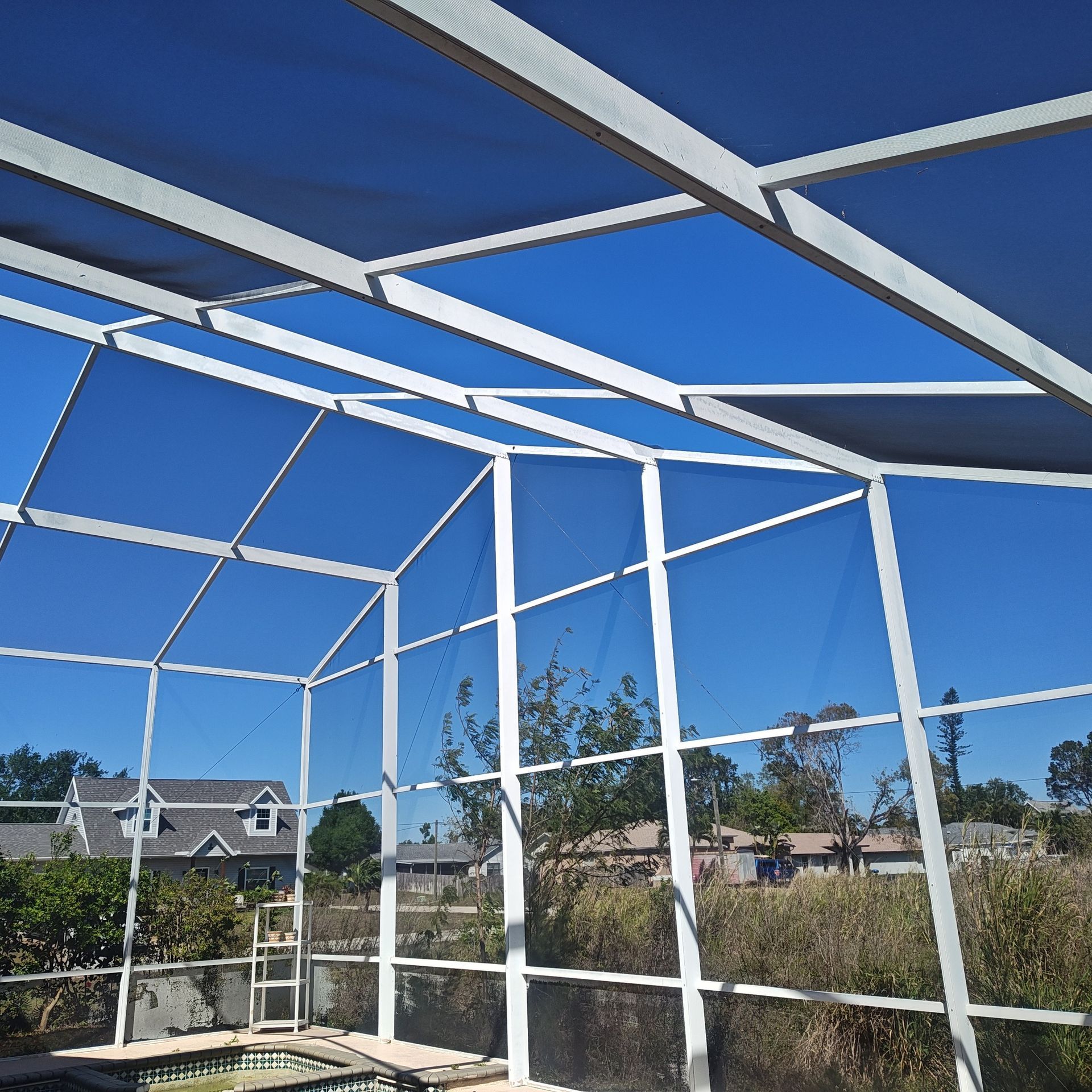 A screened in area with a blue sky in the background