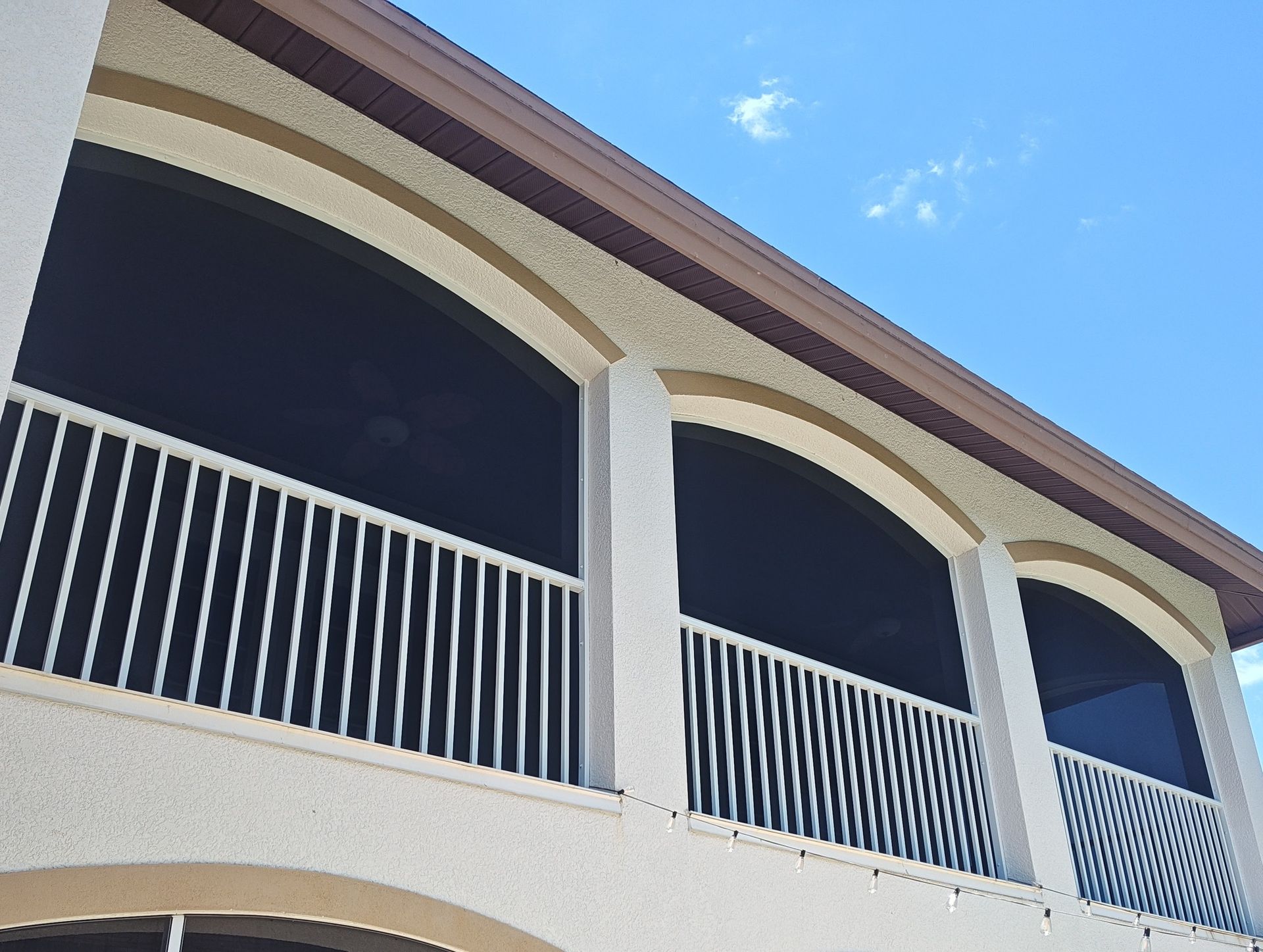 A building with arched windows and a white railing
