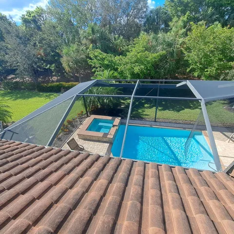 A view of a swimming pool from the roof of a house.