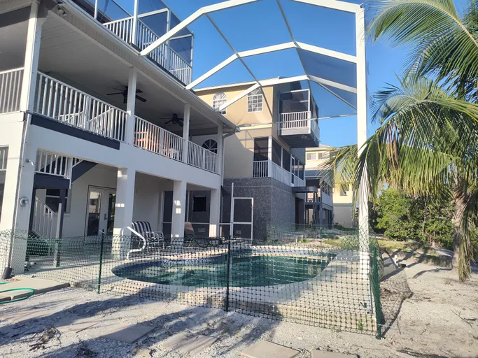 A large house with a swimming pool in front of it.