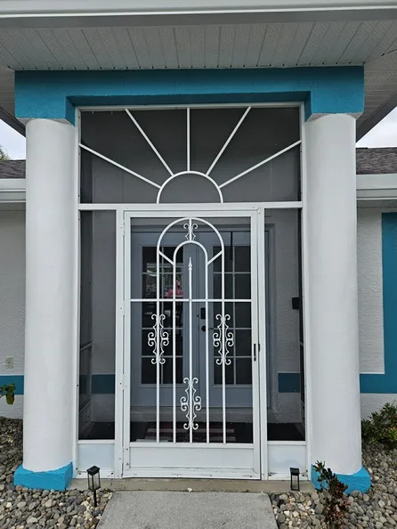 A white and blue house with a screen door