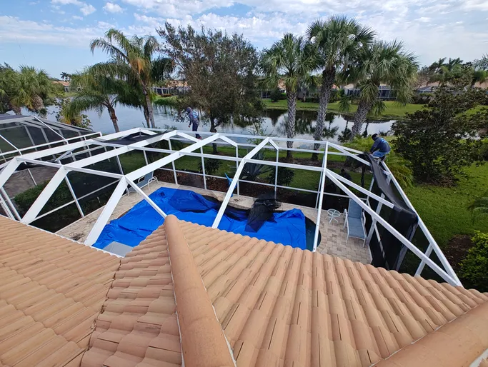 A view of a swimming pool from the roof of a house.