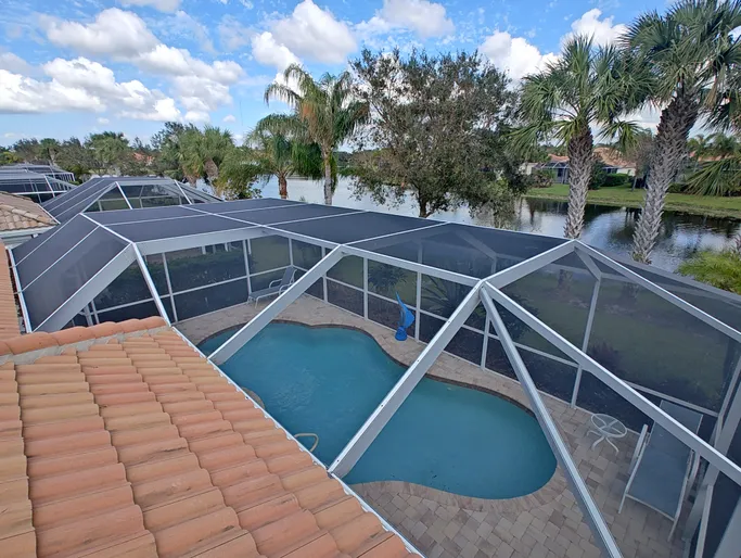 A view of a pool from the top of a house.