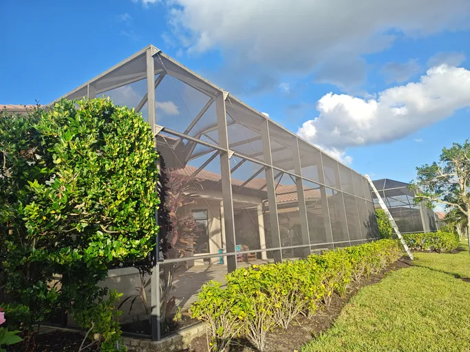 A large screened in area in front of a house.
