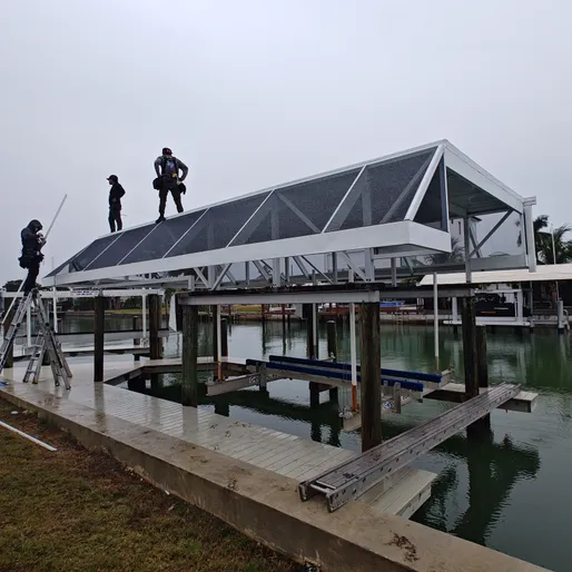 A couple of people standing on top of a building overlooking a body of water