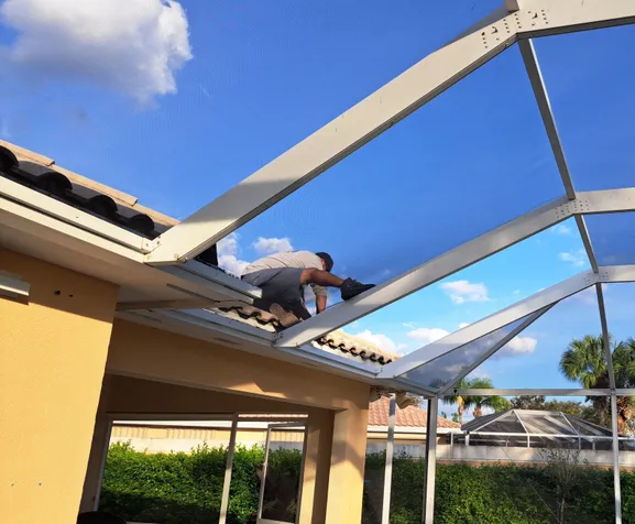 A man is working on the roof of a house