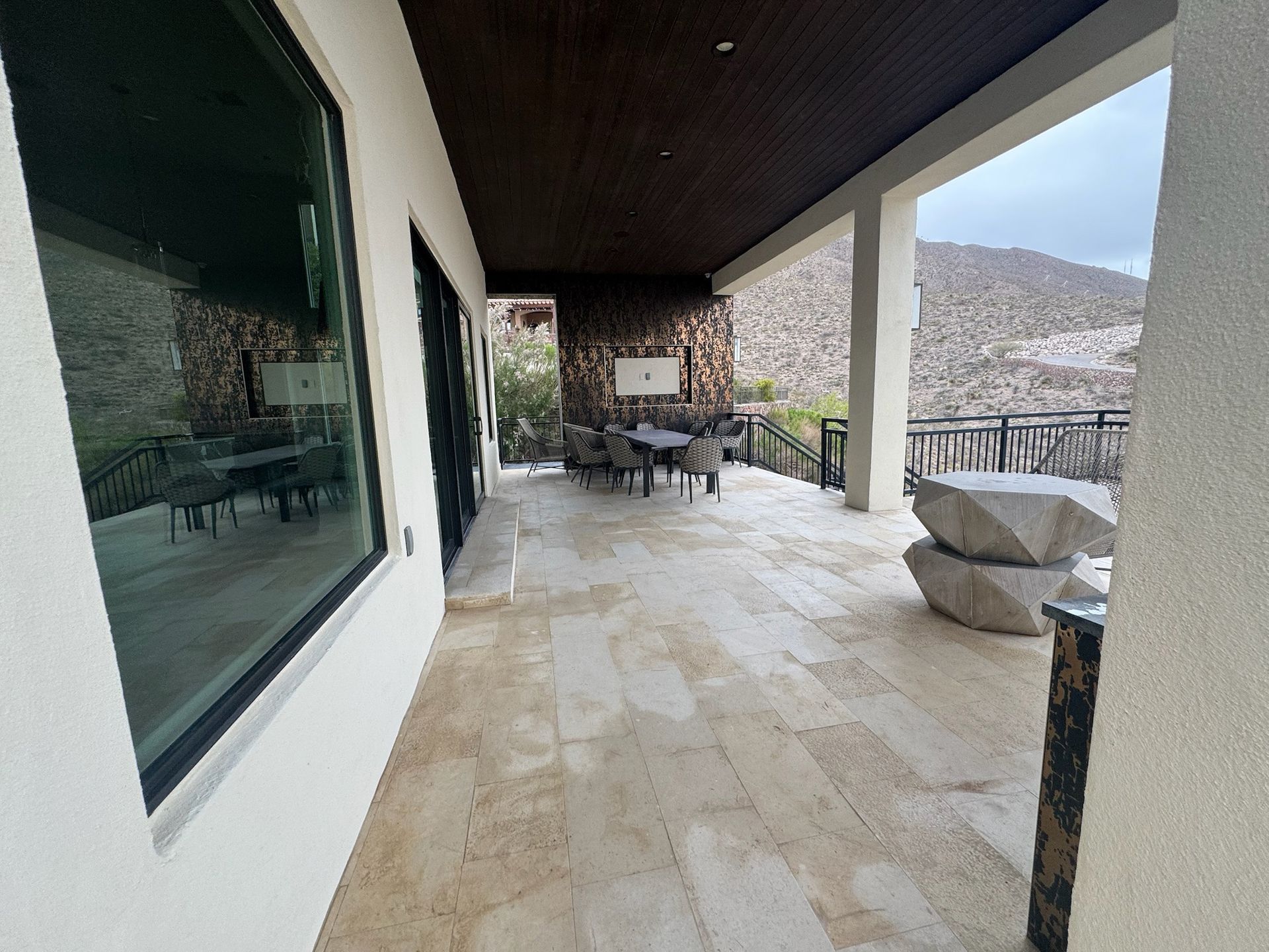 A large patio with a table and chairs on it