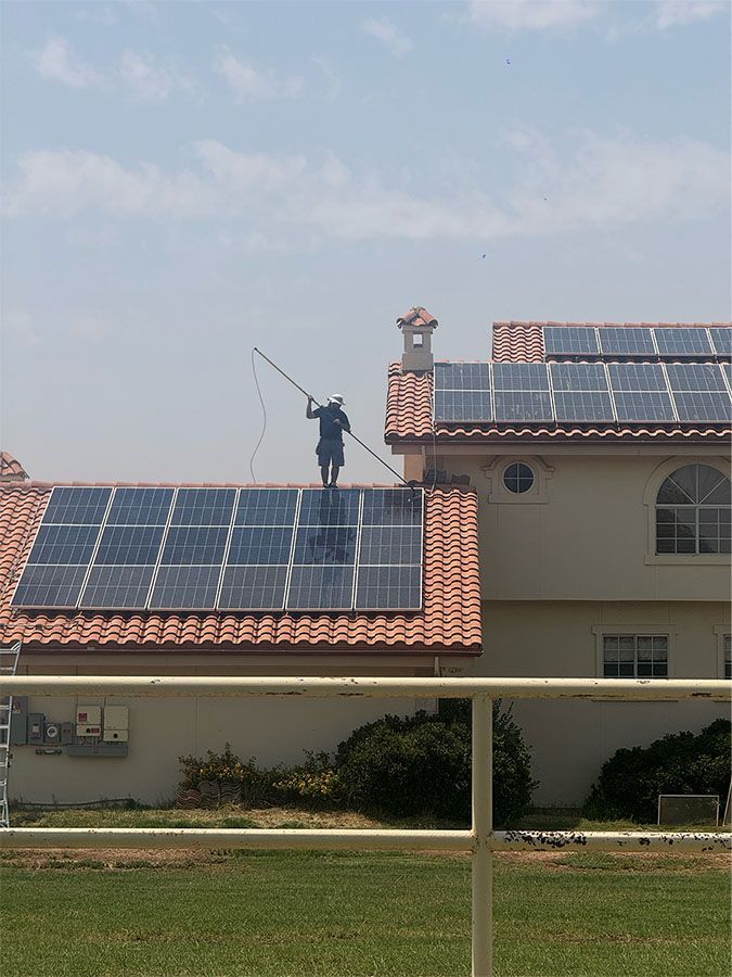 An empty living room with a large window and a swimming pool in the background.