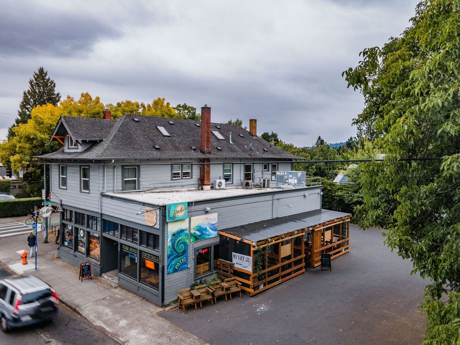 An aerial view of a building with a car parked in front of it.