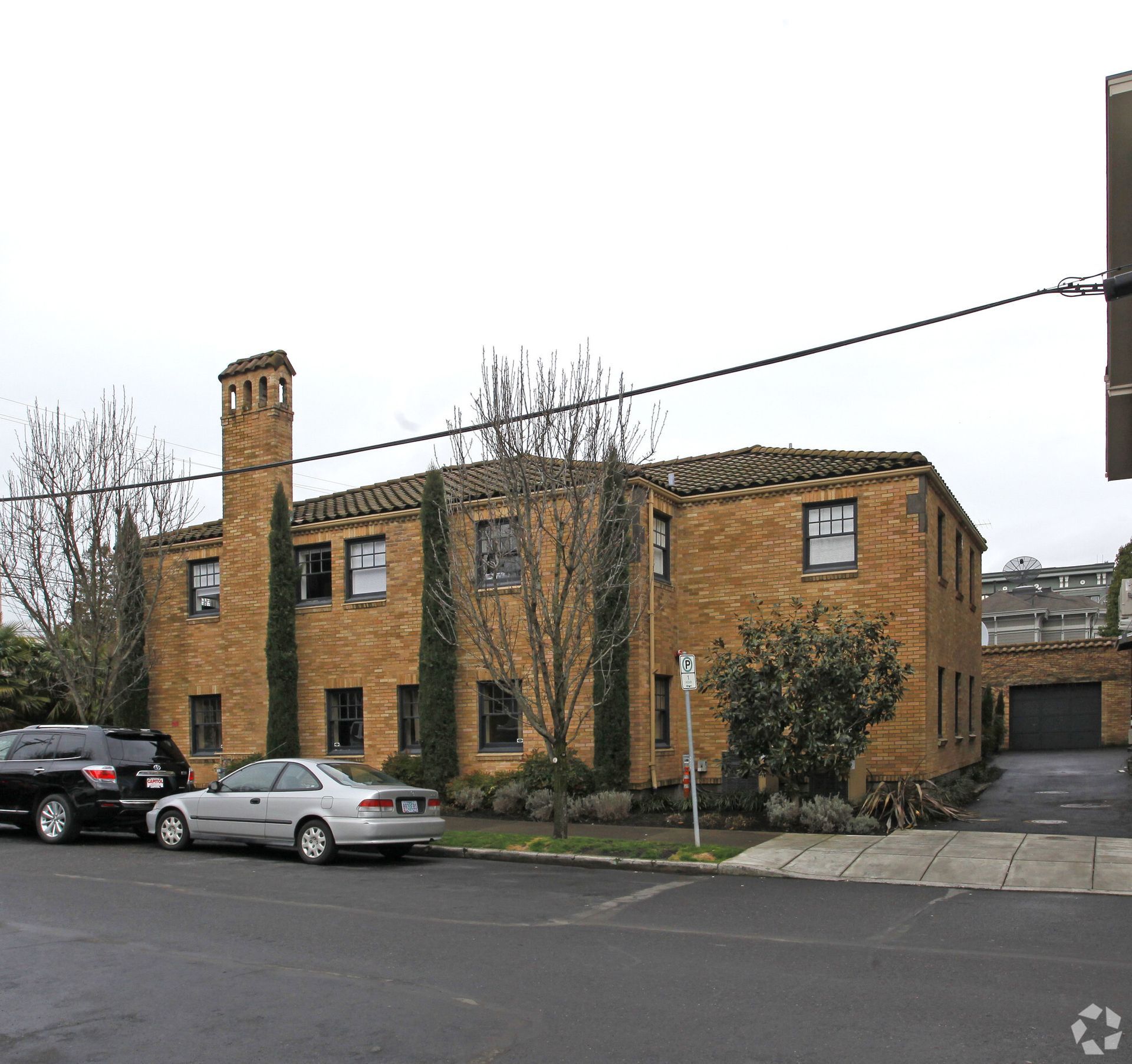 A brick building with cars parked in front of it