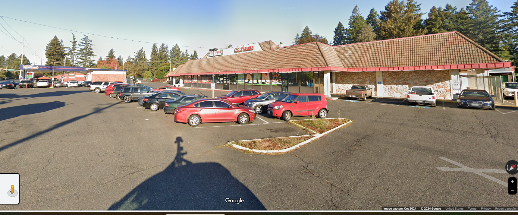A lot of cars are parked in front of a building
