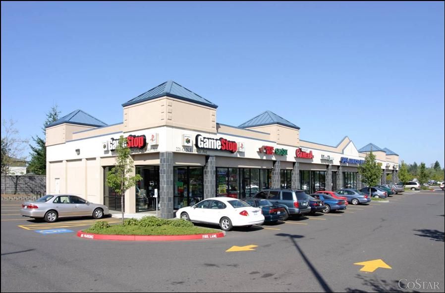 Cars are parked in front of a store called gamestop