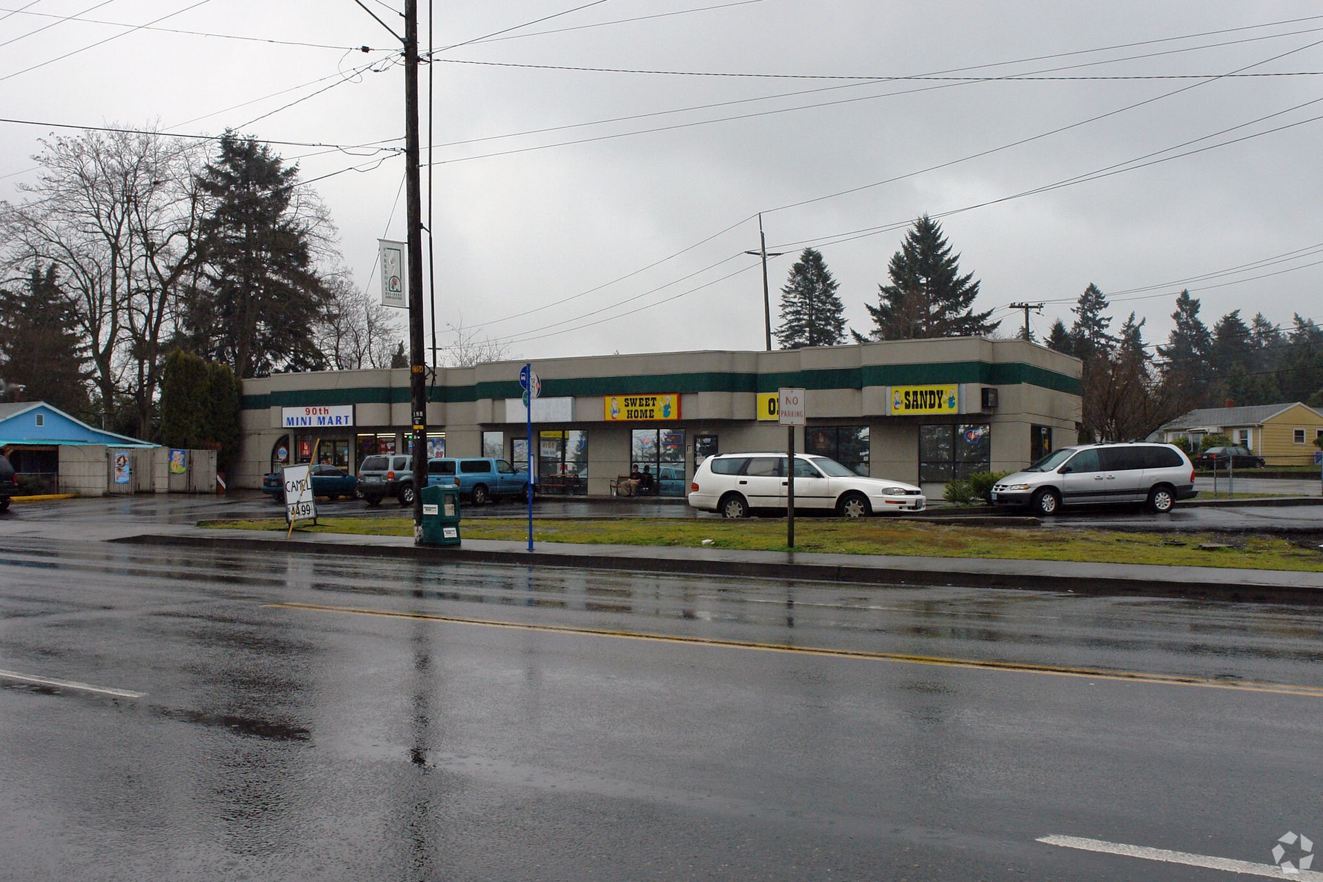 Cars are parked in front of a building that says 407