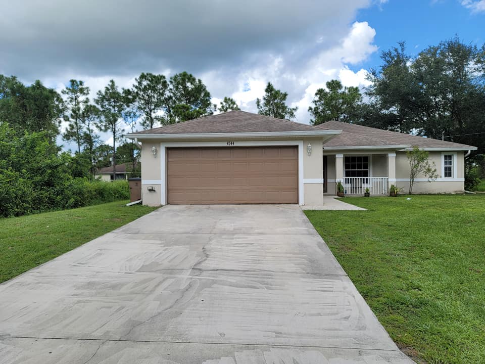 A house with a brown garage door and a concrete driveway