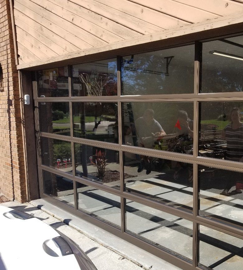 A garage door with a reflection of a car in it