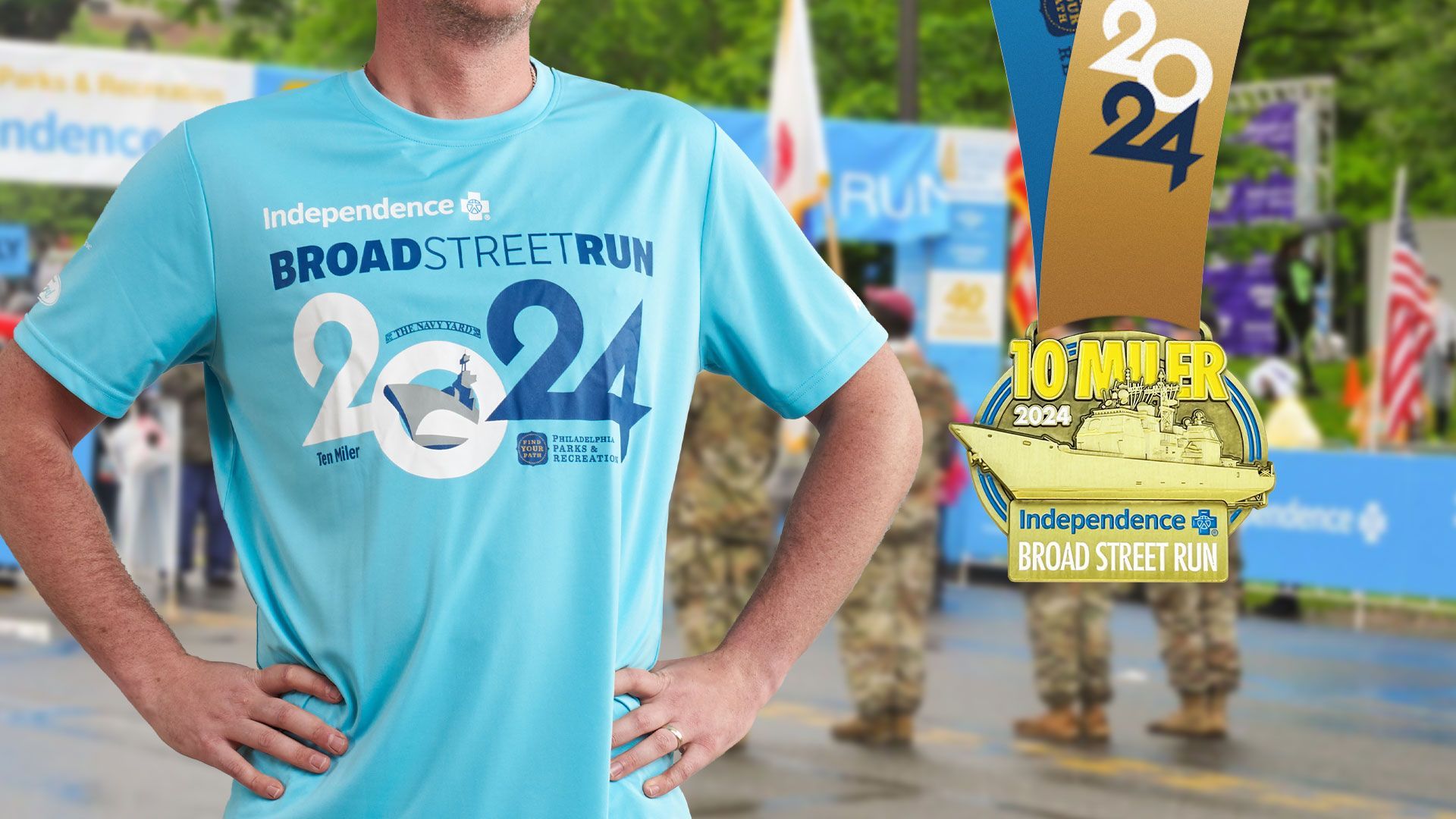 A man in a blue 2024 Broad Street Run shirt is standing with his hands on his hips in front of a 2024 Broad Street Run Finisher medal.