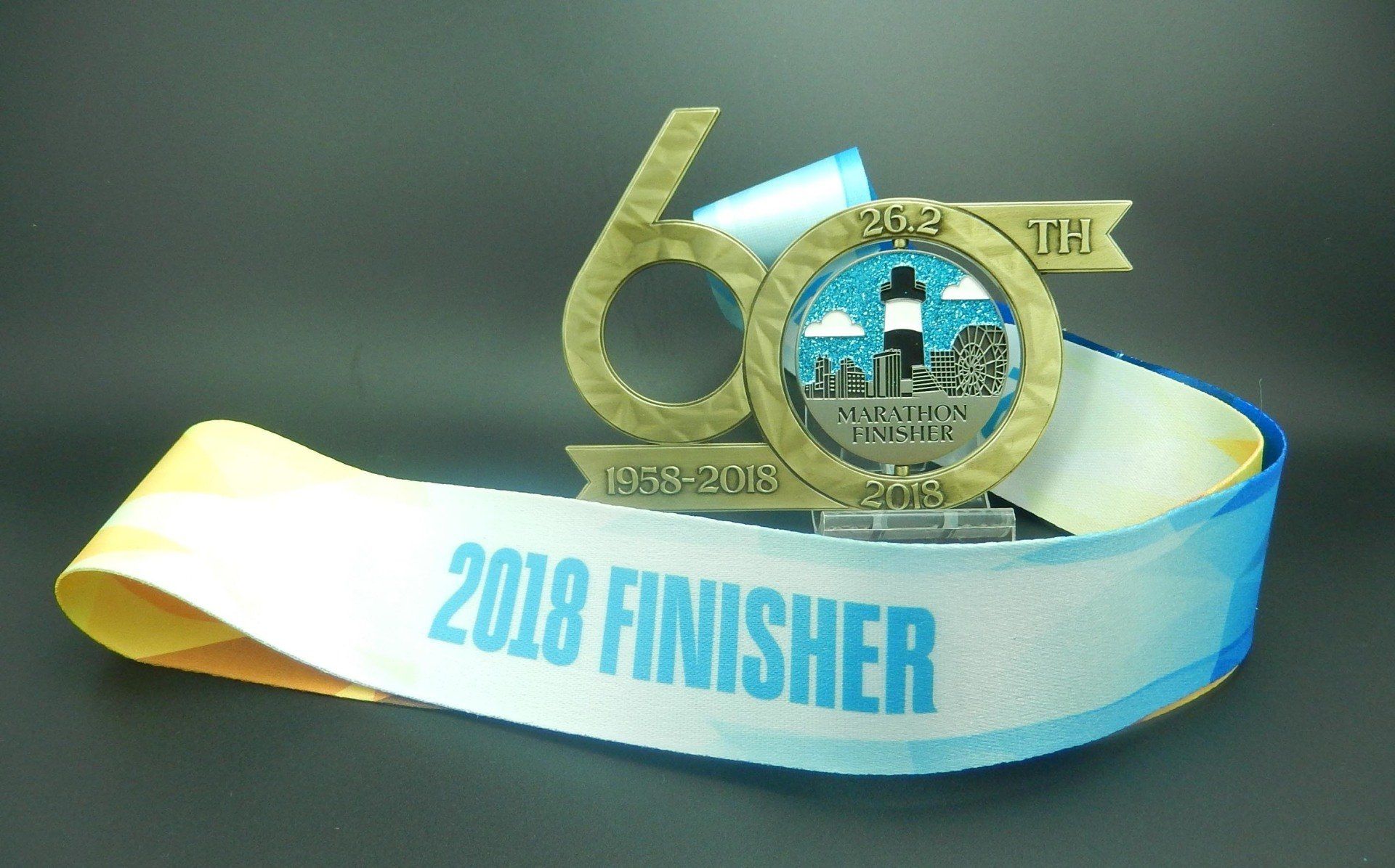 A medal that says 2018 finisher on it