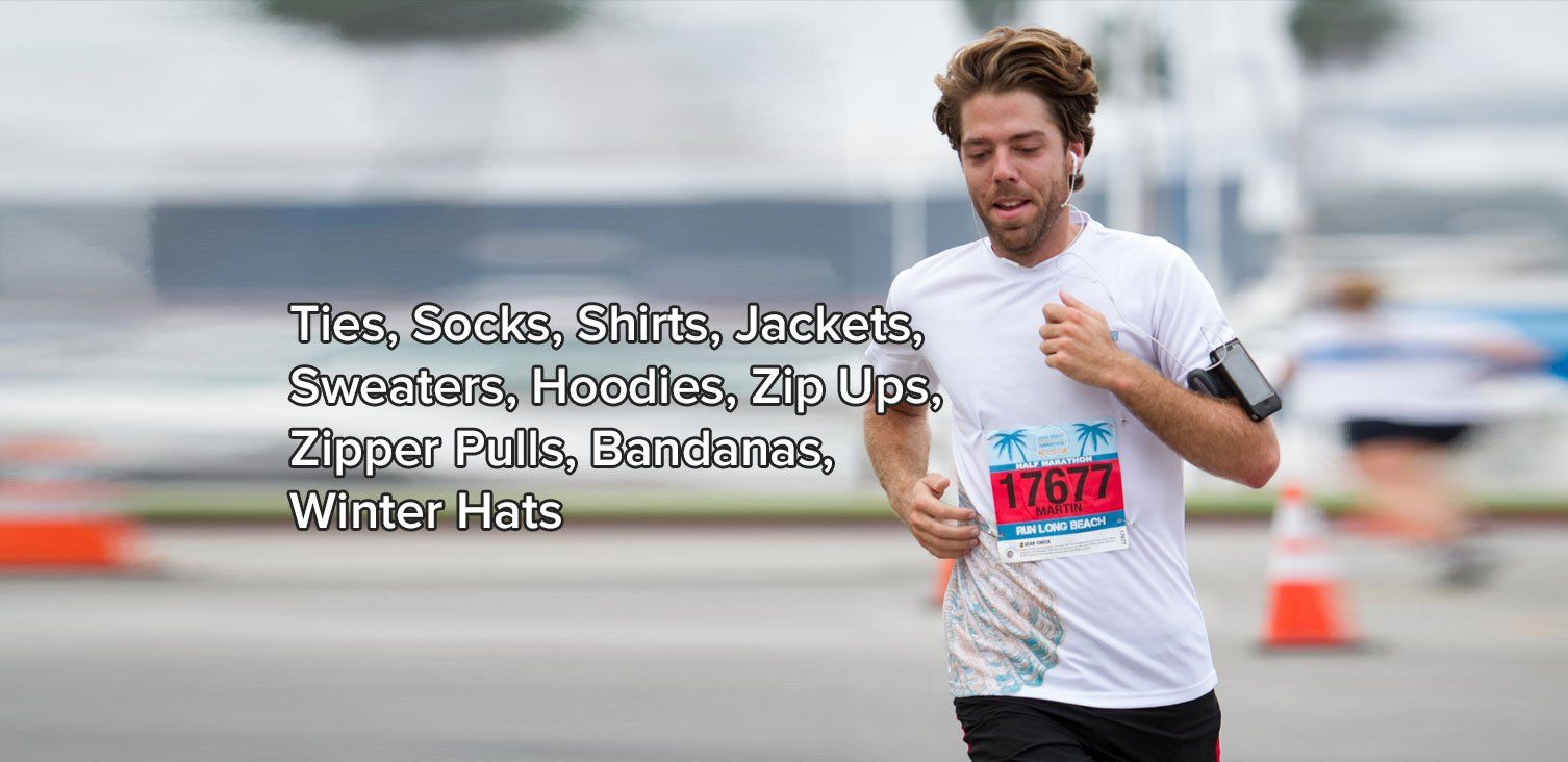 A man is running in a race wearing a white shirt and black pants.