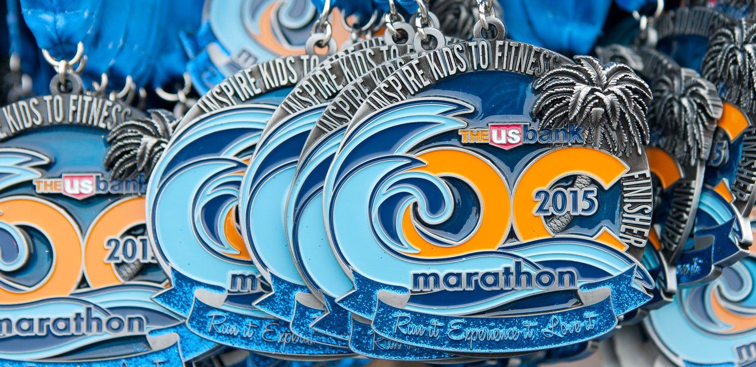 A bunch of medals from the 2013 marathon are stacked on top of each other