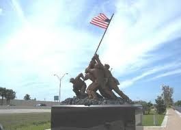 A statue of soldiers raising an american flag.