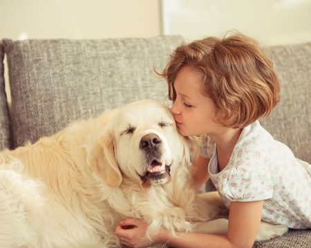 Girl kissing dog - Animal Health Center in Mirada, CA