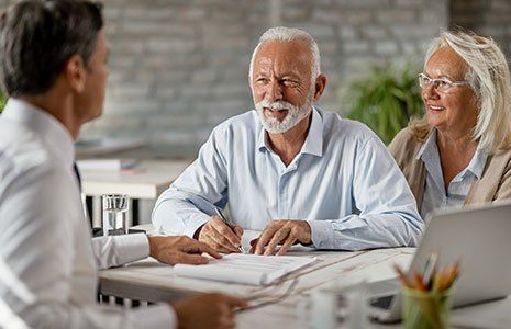 Senior Couple Signing Insurance Contract — Kingston, NH — Kingston Insurance