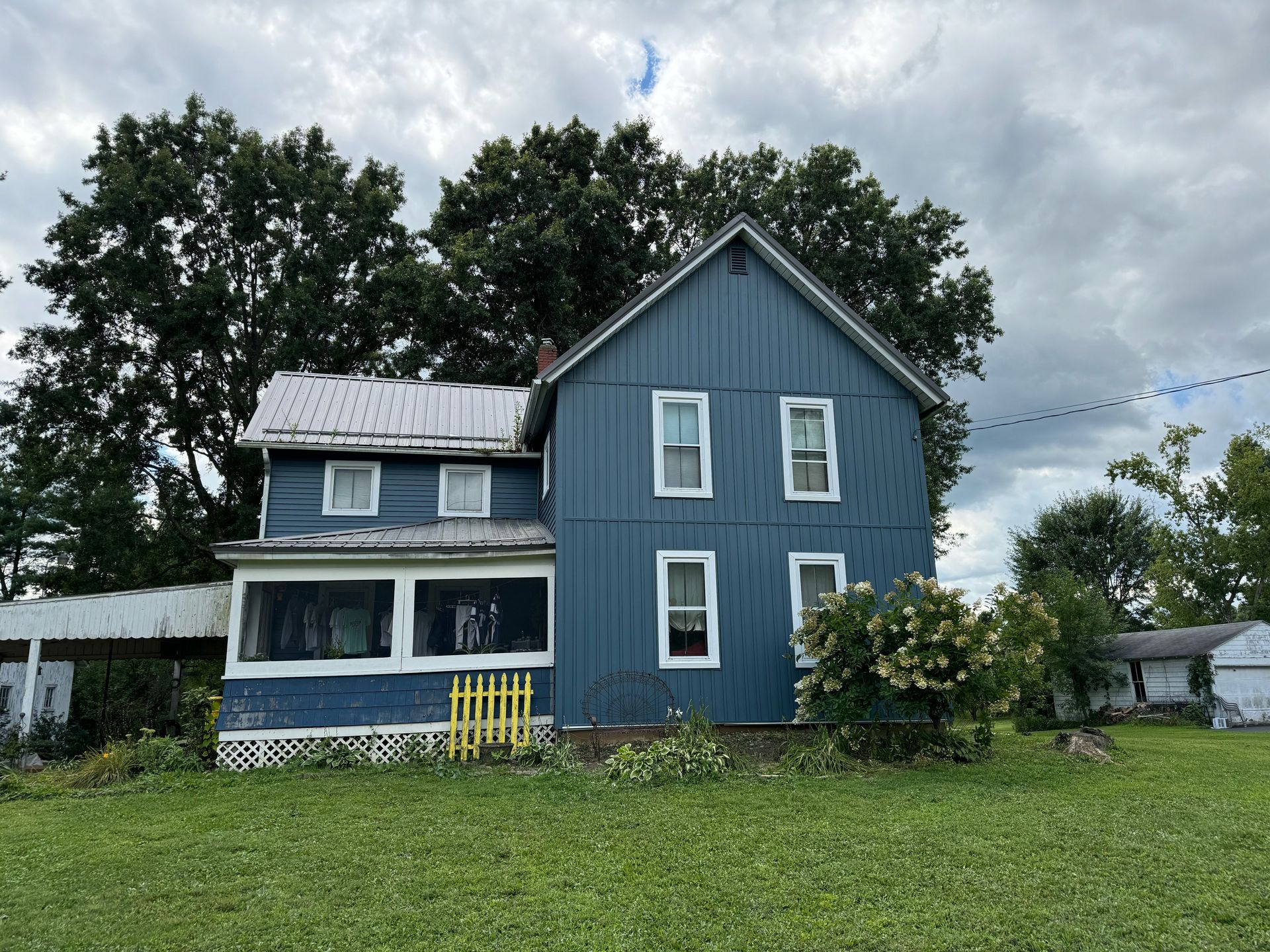 House with Blue Siding and Brick Chimney — Kent, OH — ARC Contracting of Ohio LLC