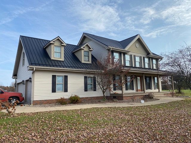 Home with new metal roof installation showing durable roofing material on residential property