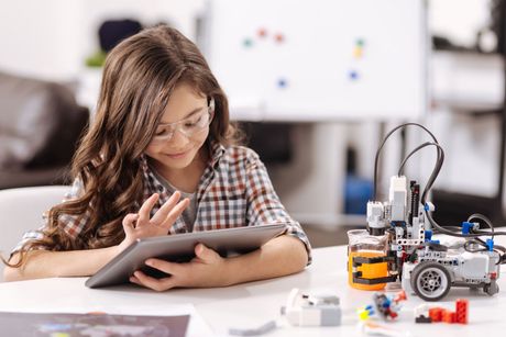 Girl Using Tablet in The Science Studio – Philadelphia, PA – Law Office of Mark W. Voigt