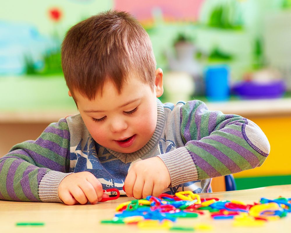 Special needs child playing in kindergarten after special education legal help from the Law Office o