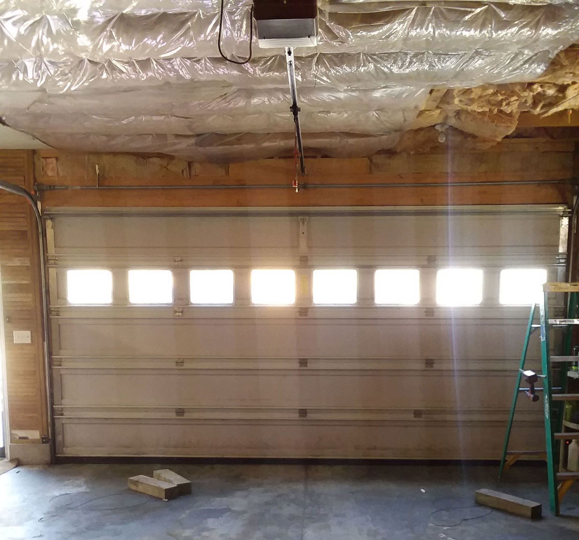 A silver tube over the door and no visible spring?