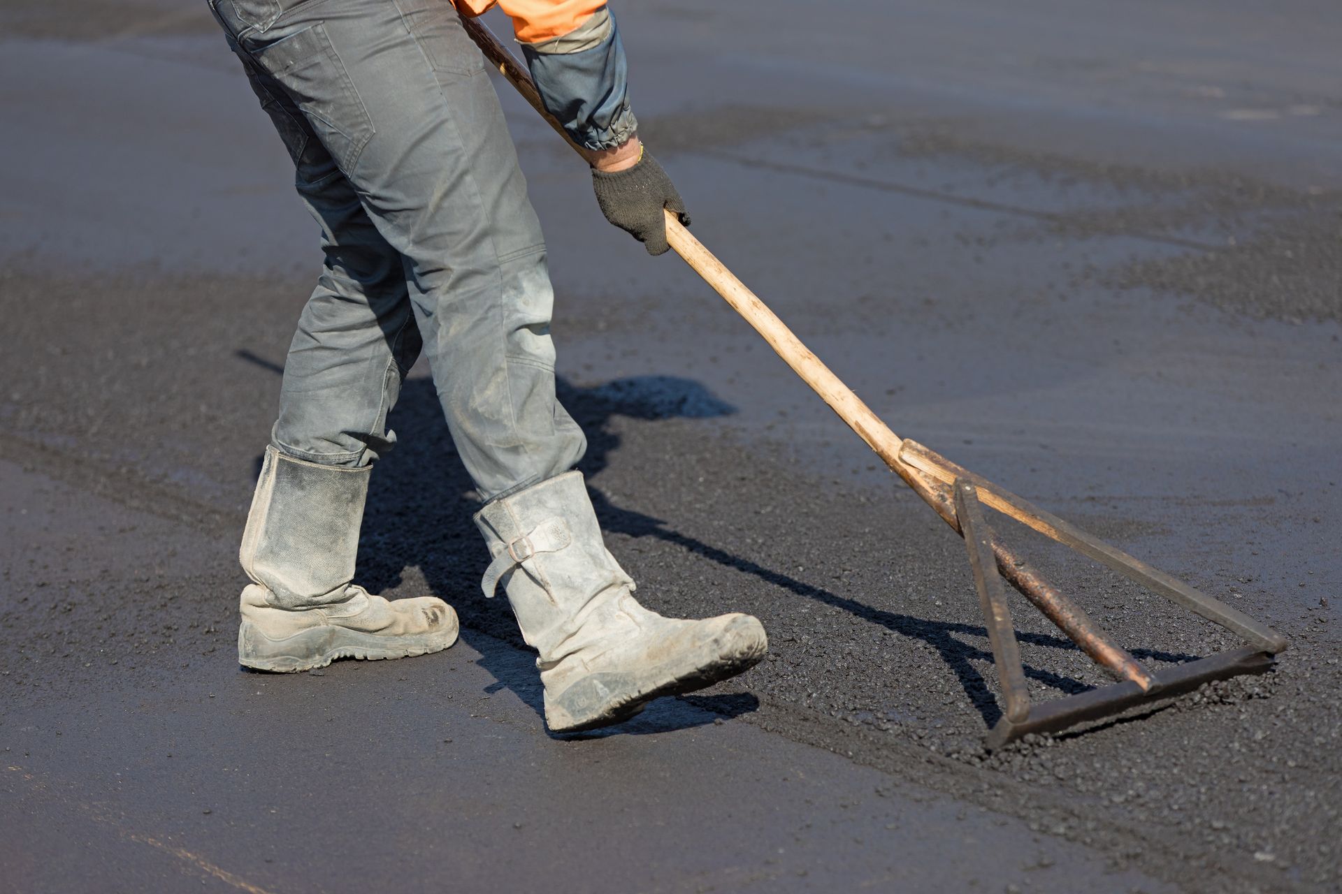 Leveling hot mix asphalt concrete pavement for smooth, flexible surface construction. Leveling hot mix asphalt concrete pavement for smooth, flexible surface construction.