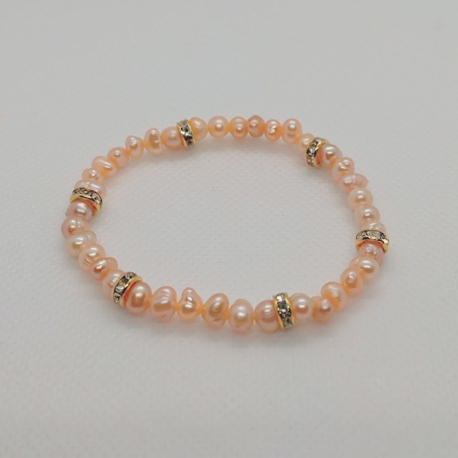 Armband op elastiek van roze zoetwaterparels met tussenkralen met zirkonia steentjes