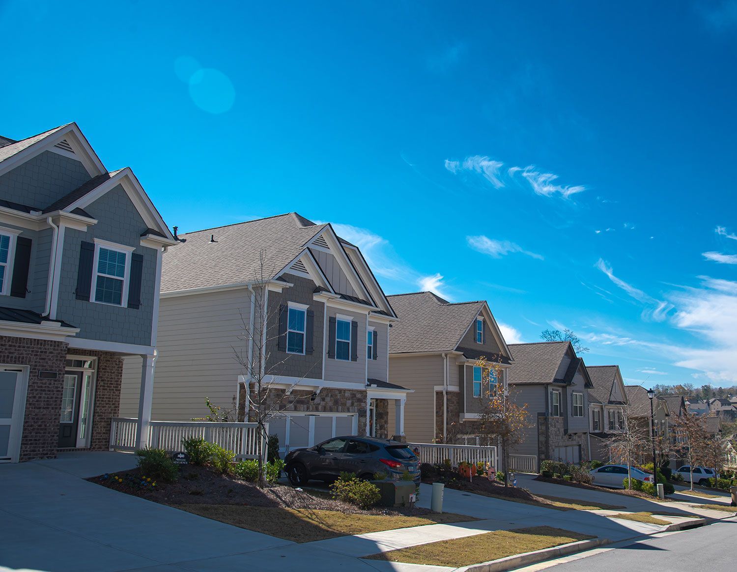 A row of modern suburban houses on a street