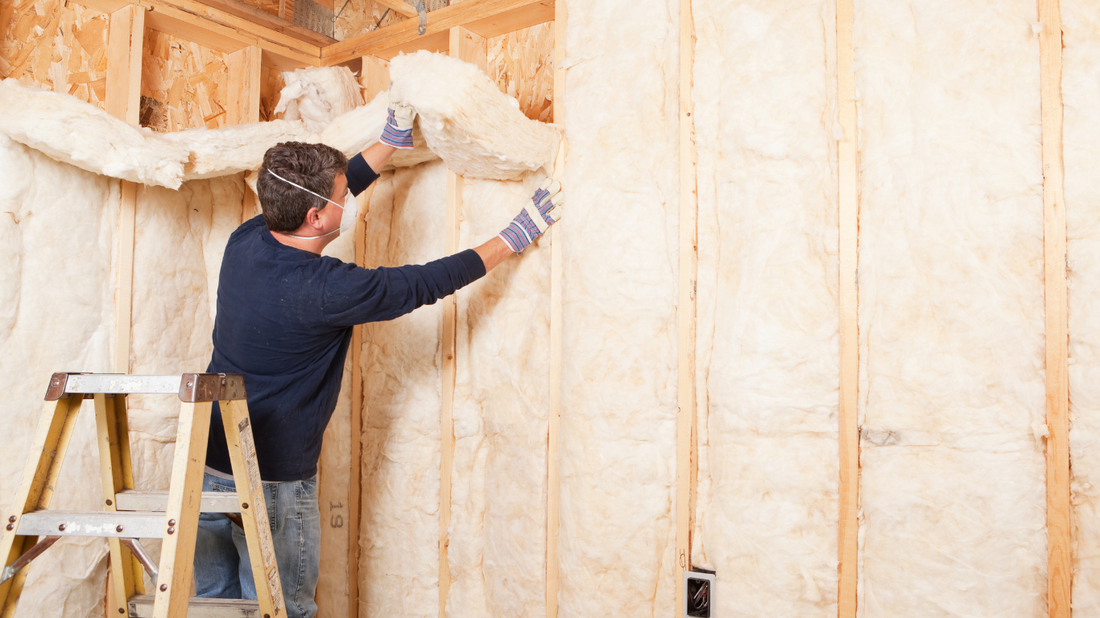 Skilled installer fitting fibreglass insulation into wall cavities, enhancing energy efficiency and reducing heat loss for a comfortable home in County Limerick.