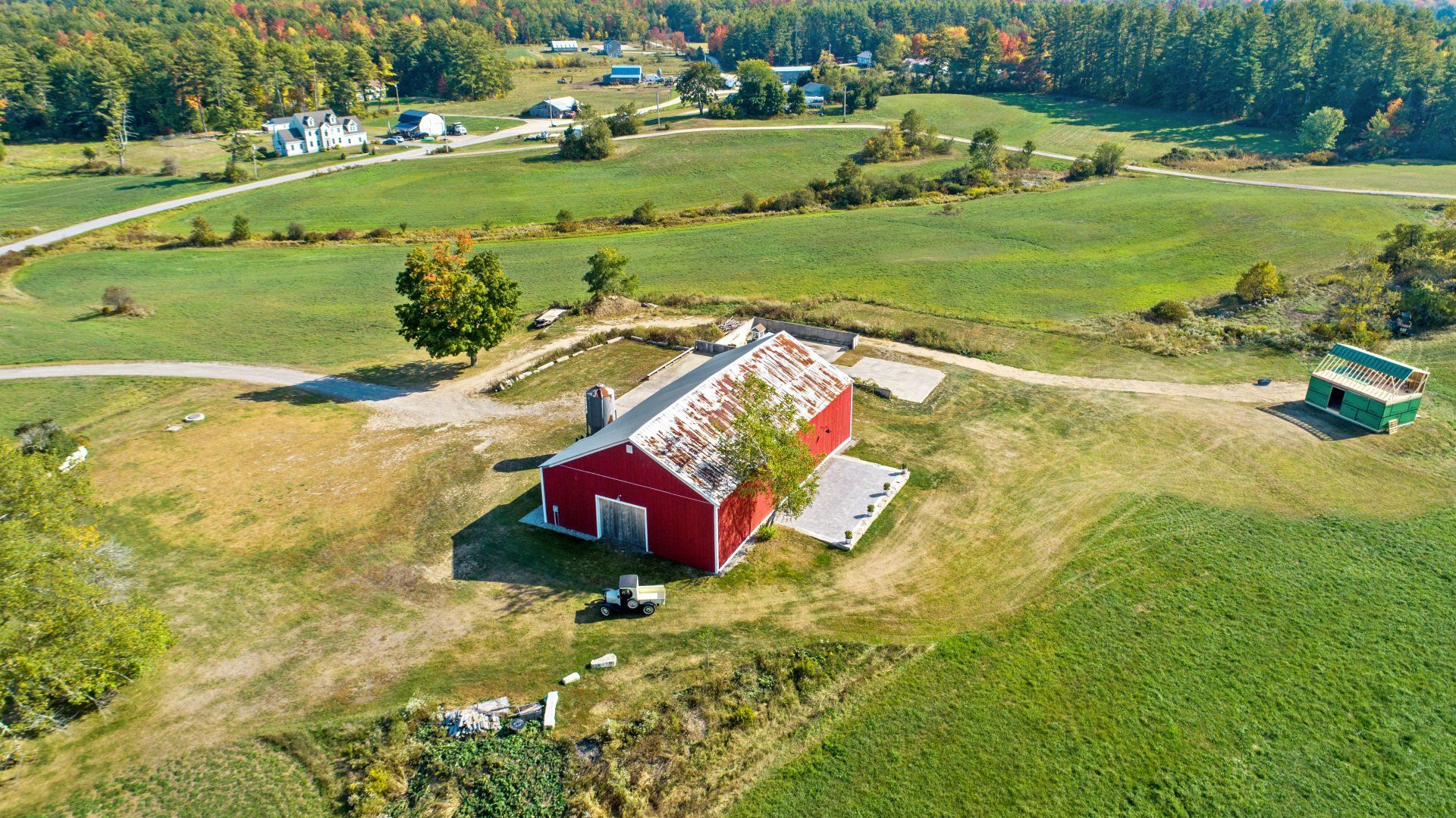 Aerial view of the barn near residential houses — Dayton, ME — This Old Barn