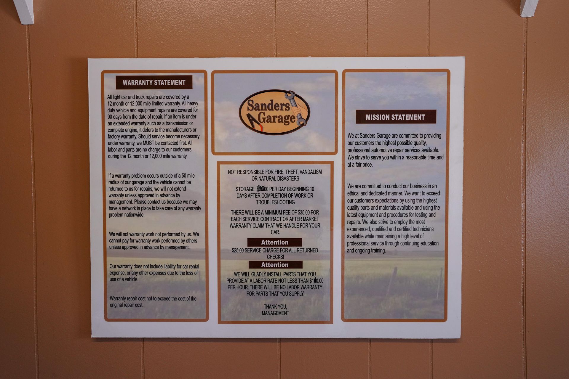 A framed information board on a brown wall displays the Sanders Nursery logo, mission statement, and company values.