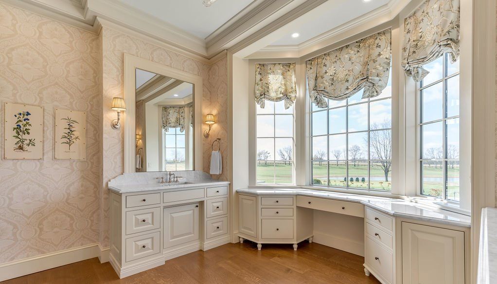 A bathroom with two sinks , a mirror , and a large window.