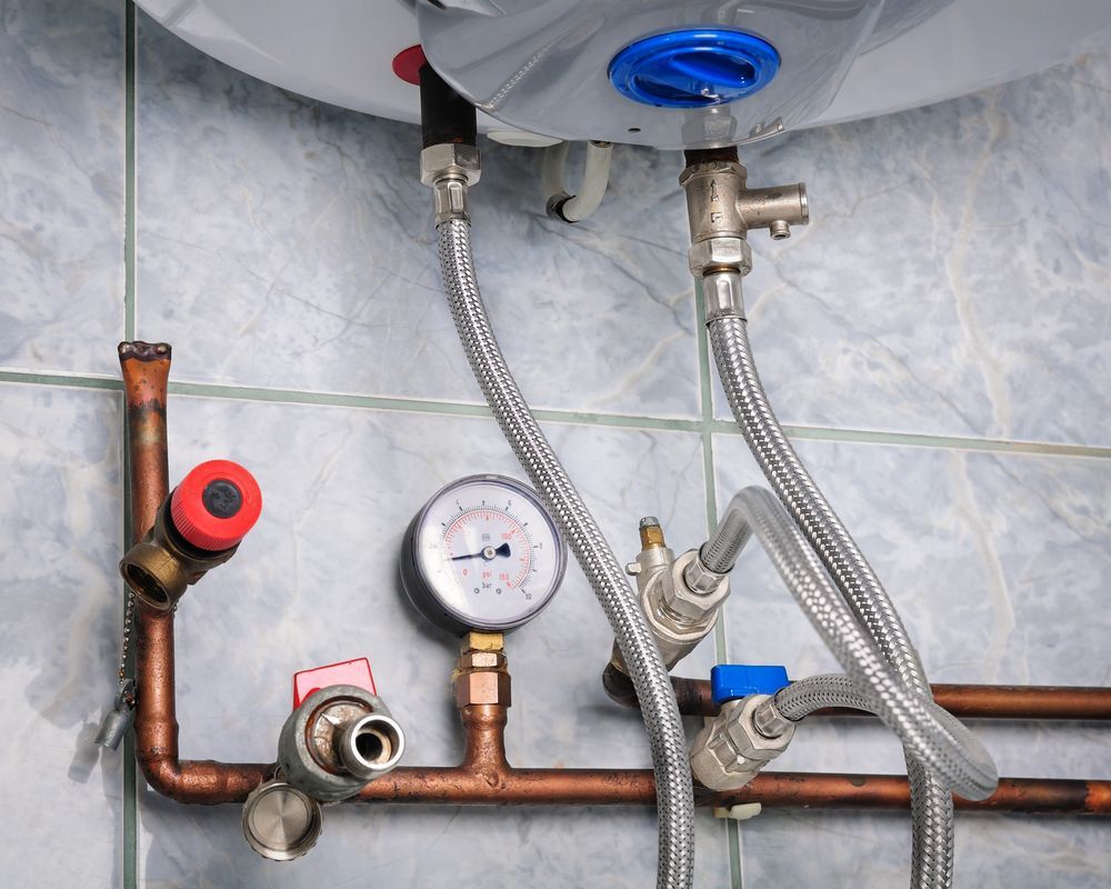 Under-Sink Plumbing with Copper Pipes Attached to A Water Heater — NoDrip Plumbing & Roofing In Port Macquarie, NSW