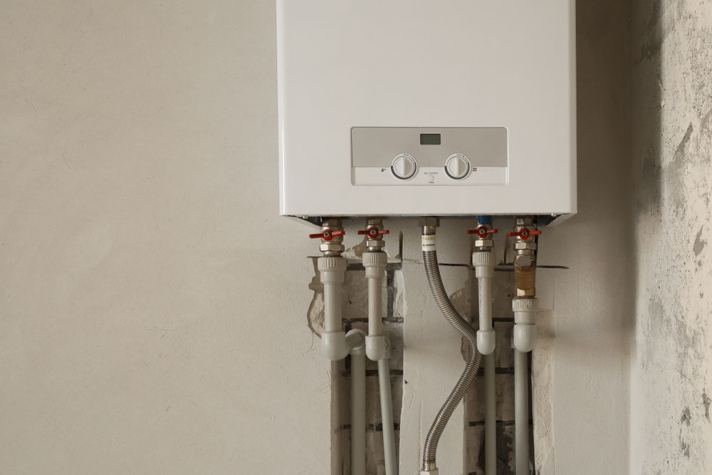 Wall-Mounted Gas Water Heater with Exposed Pipes and Valves  — NoDrip Plumbing & Roofing In Port Macquarie, NSW