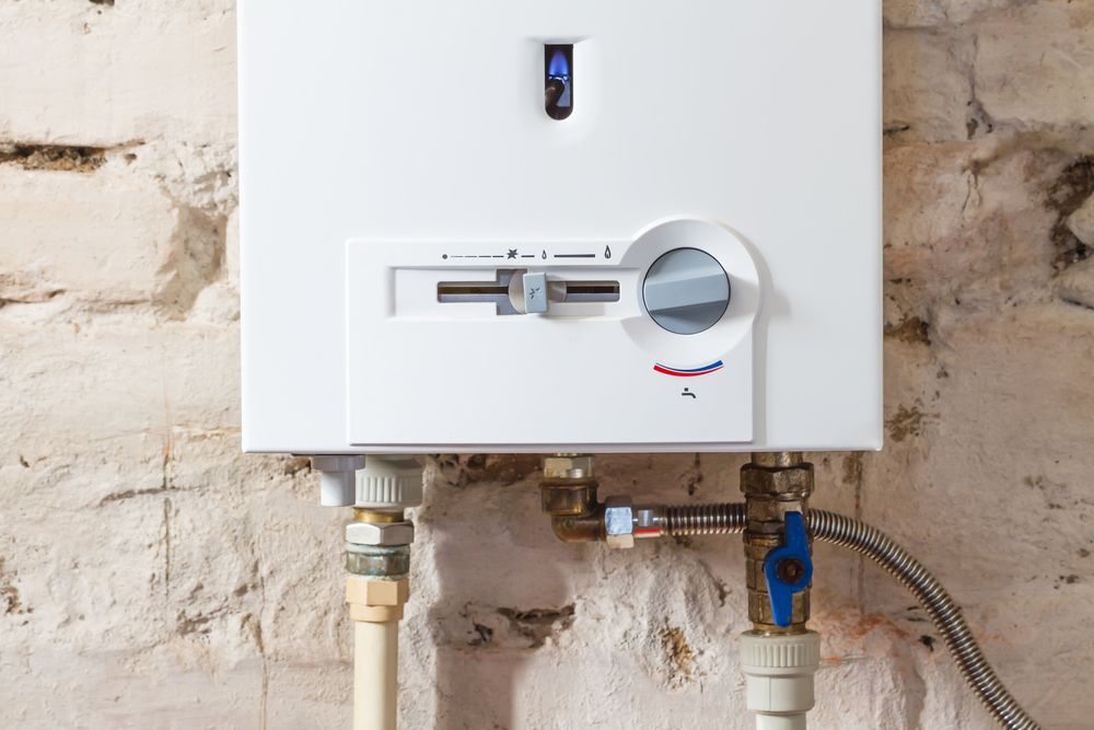 White Wall-Mounted Gas Boiler on A Rough Brick Wall — NoDrip Plumbing & Roofing In Port Macquarie, NSW